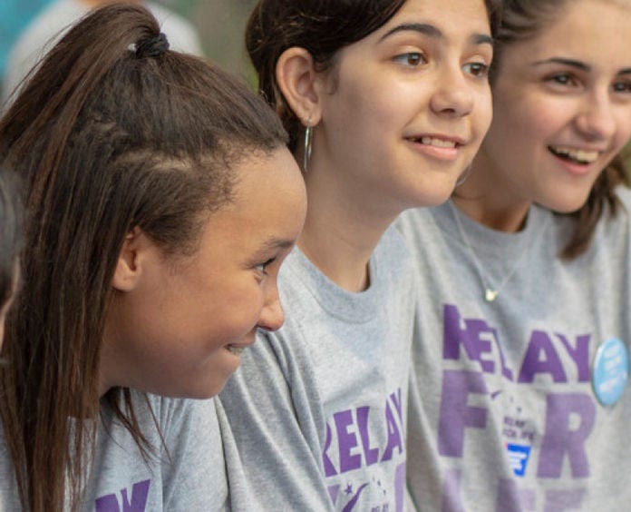 three young girls smiling