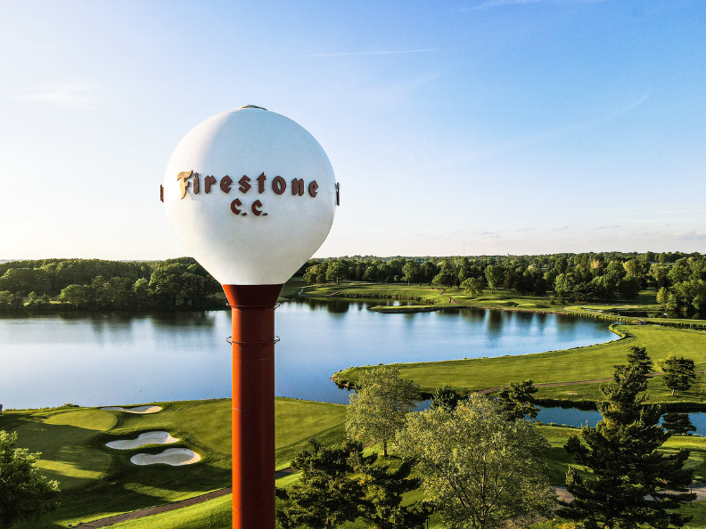 Water tower labeled 'Firestone C.C.' overlooking golf course and lake.