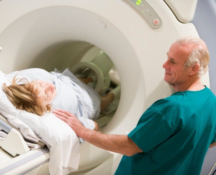 male doctor with female patient during a ct scan