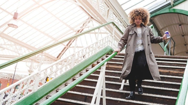 woman running down steps at train station