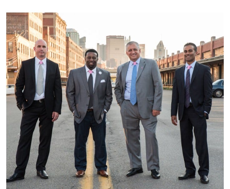 Men wearing suits standing in the street