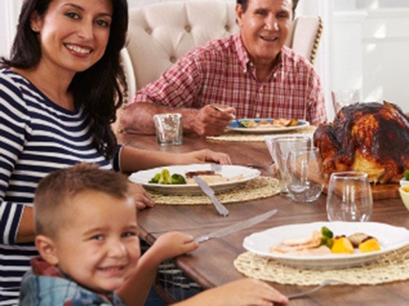 happy family eating together at table