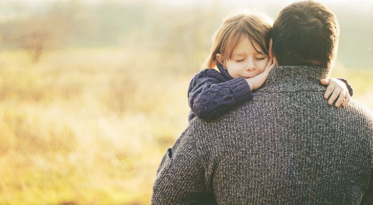 father holding his young daughter