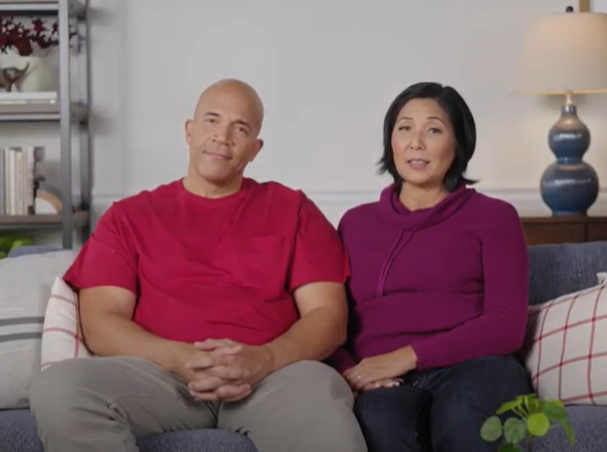 Video still showing a couple sitting on a couch