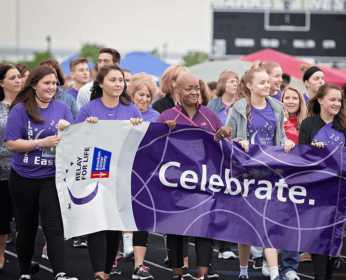 group of women holding Relay for life marathon banner