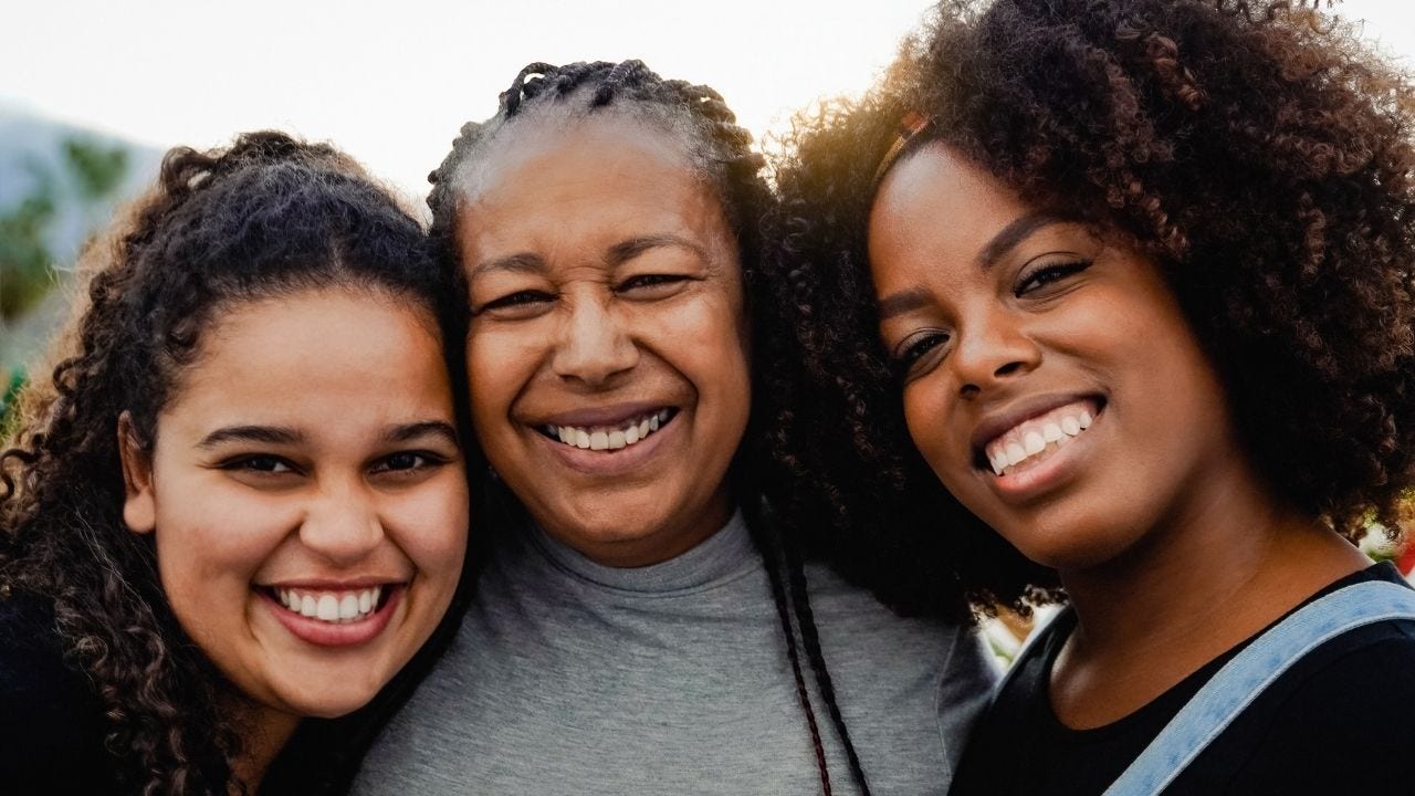 three black women smiling for a photo