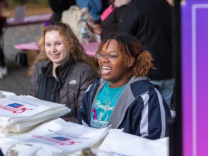two women volunteering at a youth event