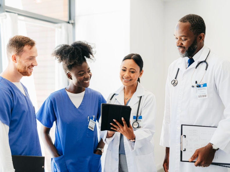 Four doctors looking at a chart