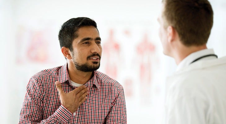 man talking to his doctor in the exam room