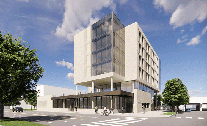 Modern elevated building with glass corner and street-level activity.