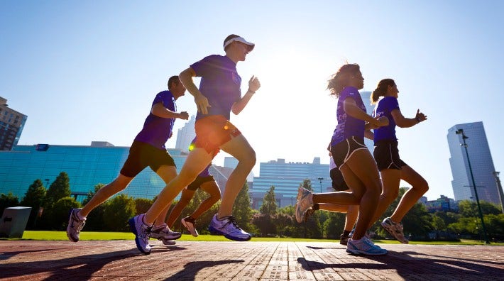 group of runners in city park