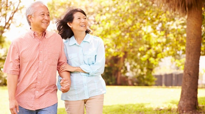 senior Asian couple walking outside