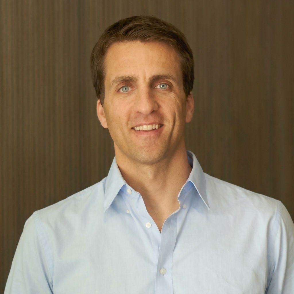 Portrait of Justin Butler with a brown background