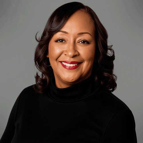 Smiling woman in black top, professional headshot.