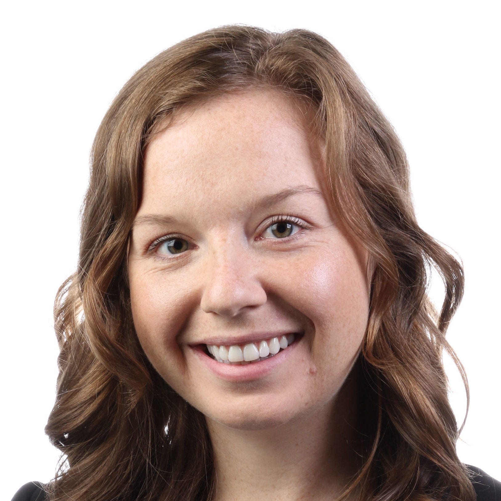 Elizabeth Schafer Headshot, black blazer, white top with black polka dots
