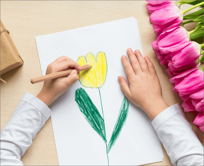 child drawing picture of yellow tulip flower