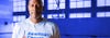 NBA star Alonzo Mourning posing for photo inside of basketball court with American Cancer Society Shirt on