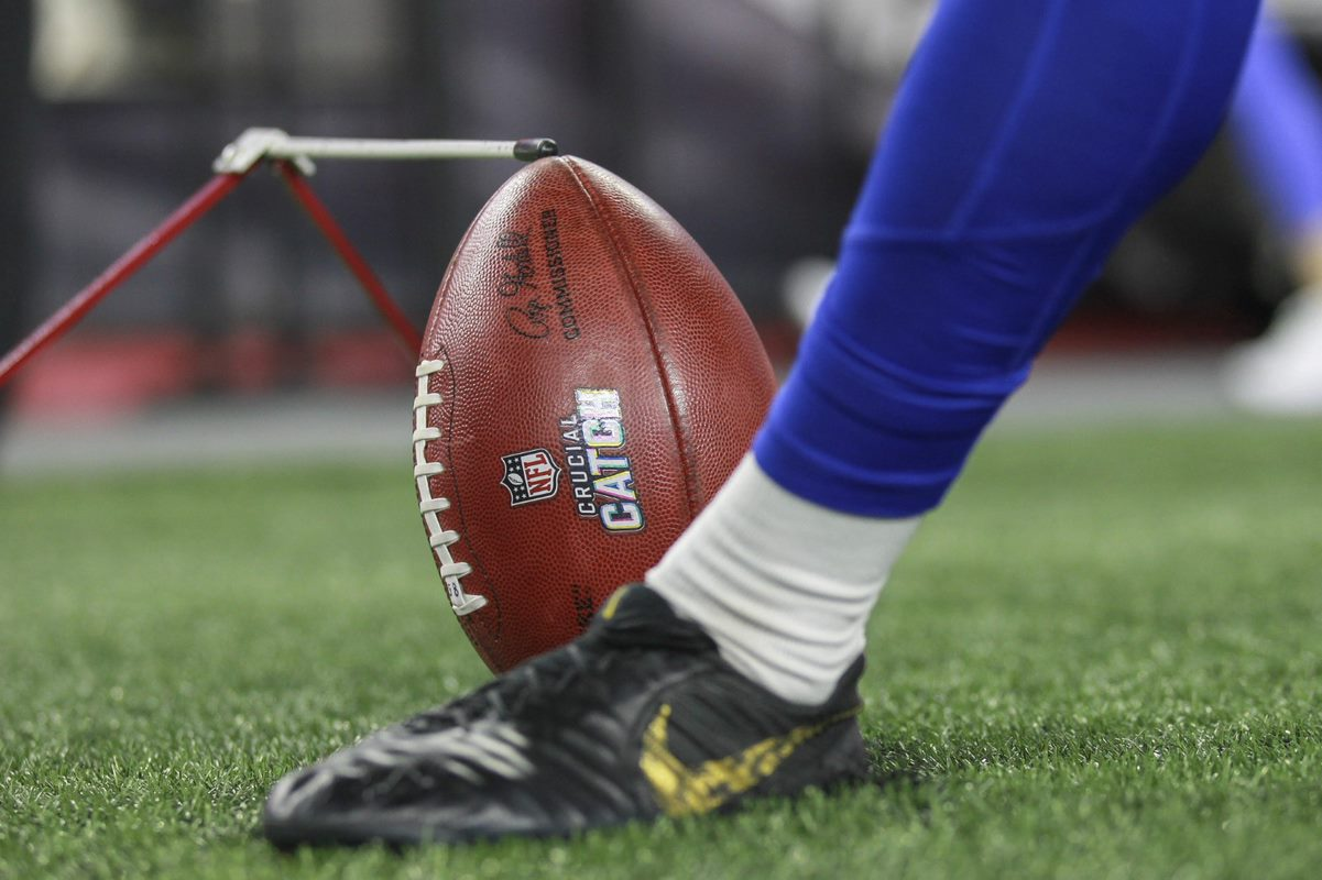 punter about to kick football on the field