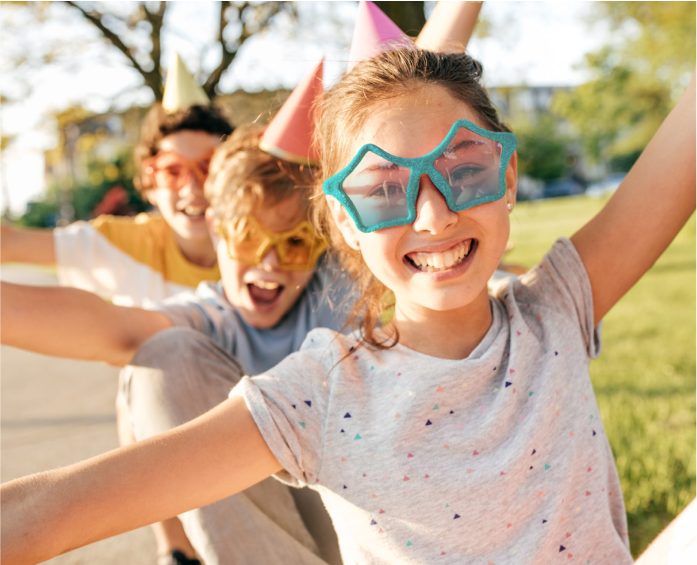 kids wearing silly glasses while playing outside