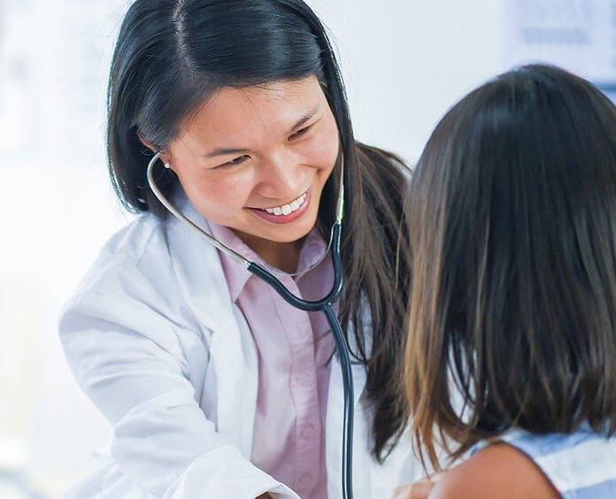 Asian female doctor with child patient