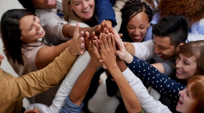 large group of young people high fiving