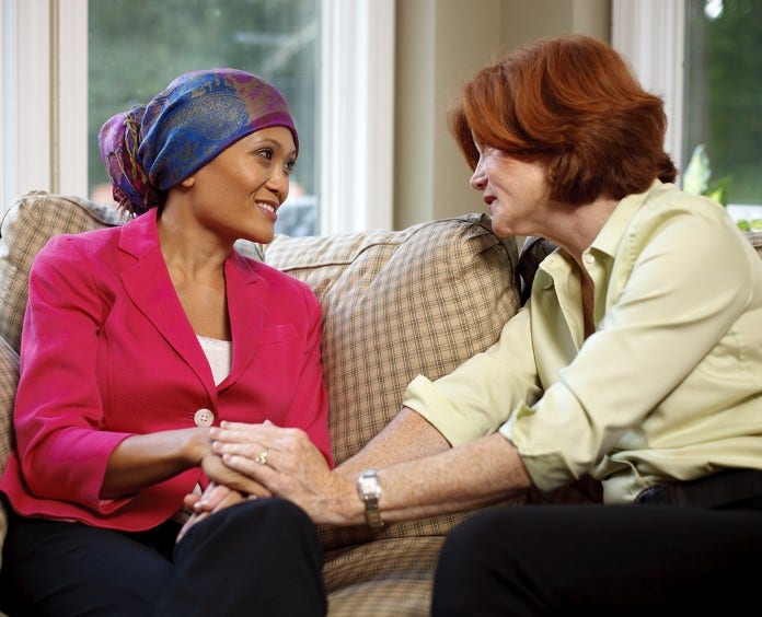 woman comforting a female cancer patient