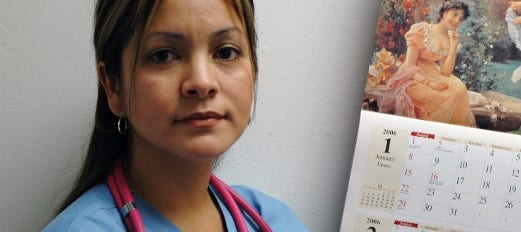 nurse standing in front of a calendar