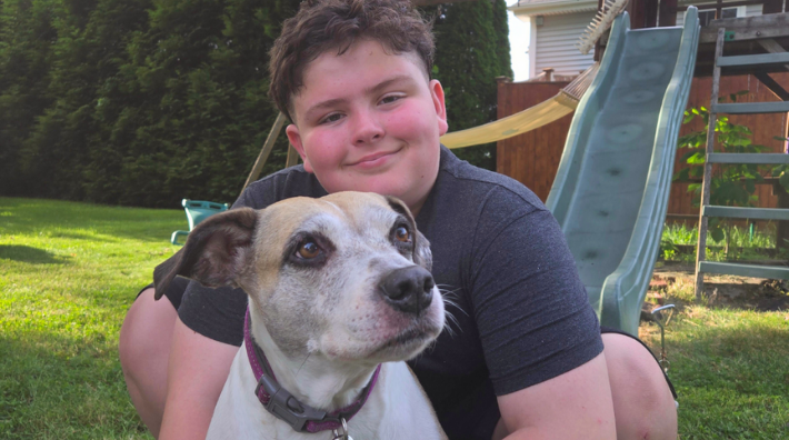 Stevie Raposo and his dog in front of a playground