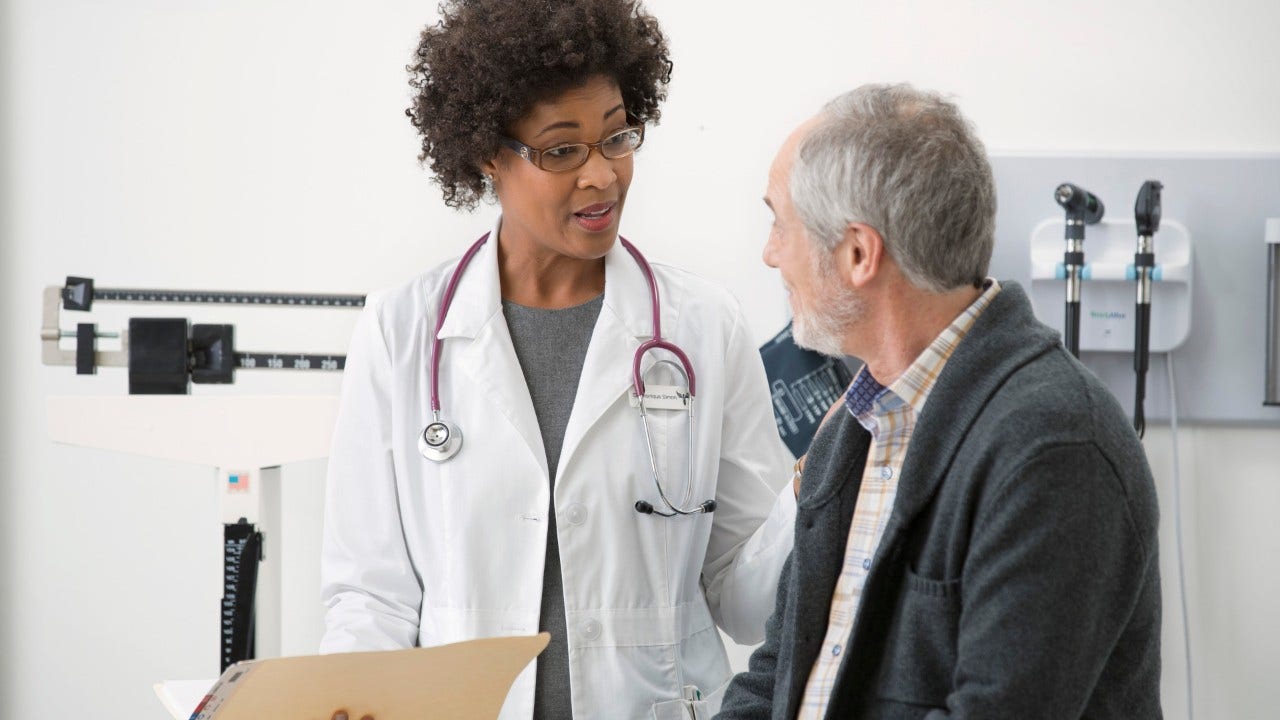 doctor talking to patient in exam room