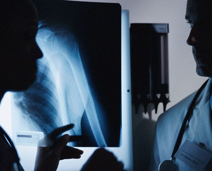 Two doctors looking at an x-ray in an office