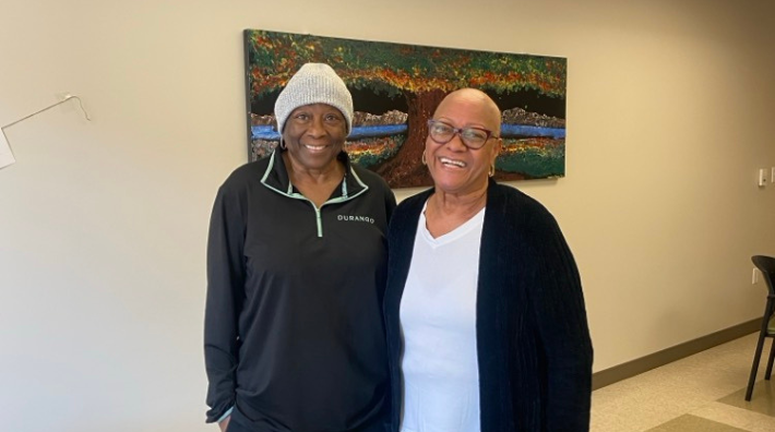 Long-time friends Irma McCoy and Evelyn Ealy smile in the lobby of a Hope Lodge
