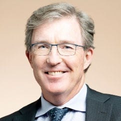 Headshot of 2026 Medal of Honor recipient, Tyler Jacks, PhD, in navy suit and tie