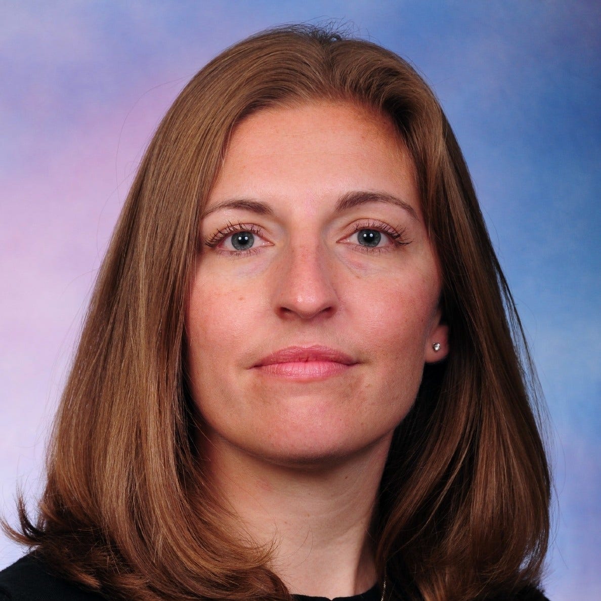 woman with shoulder-length red hair blue eyes