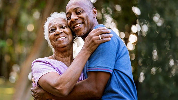 senior African-American man and woman embraced in a hug