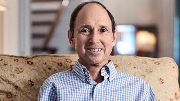 Cancer survivor, Jim, sitting on sofa