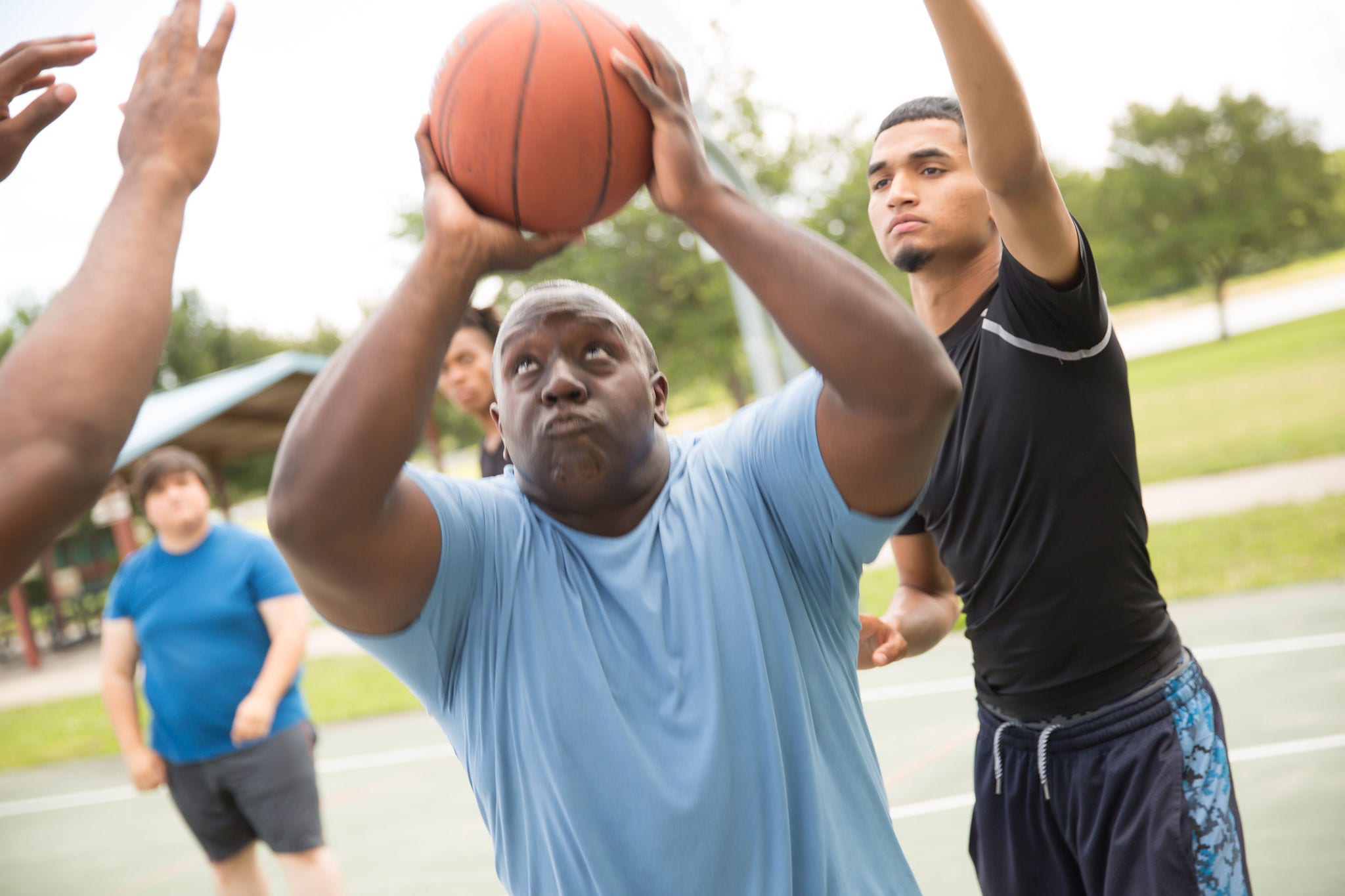 overweight black man ready to shoot basketball