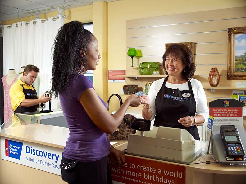woman purchasing products at a Discovery Shop store
