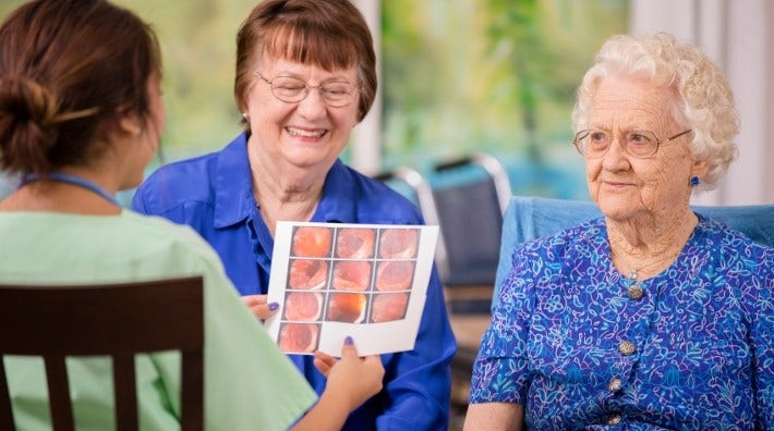 a woman and her mother go over colonoscopy results with a nurse