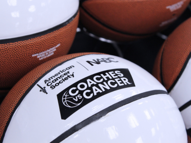 White basketballs with Coaches vs. Cancer logo printed.