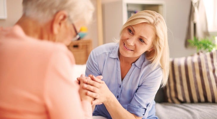 kind woman comforting an older woman