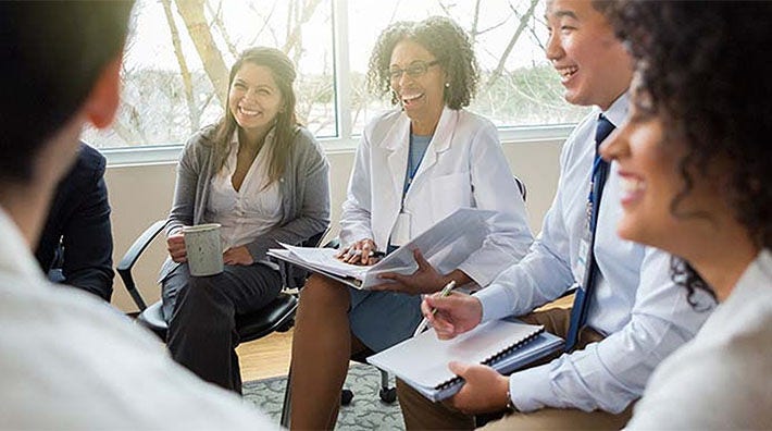 Group of healthcare professionals seated in having a group discussion