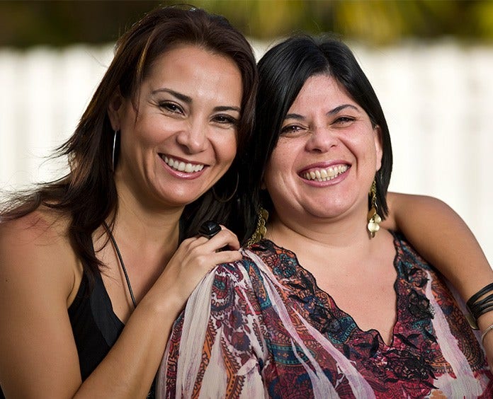 Smiling friends posing outdoors.    Do not rename this photo once downloa