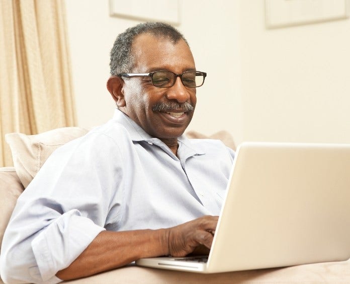 African American man using his laptop at home