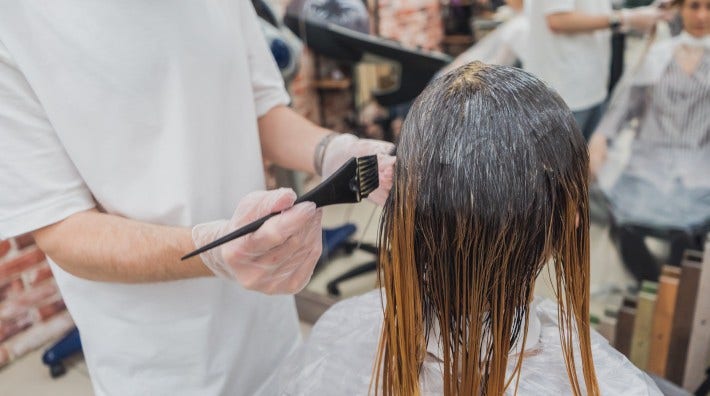 woman at salon having her hair dyed