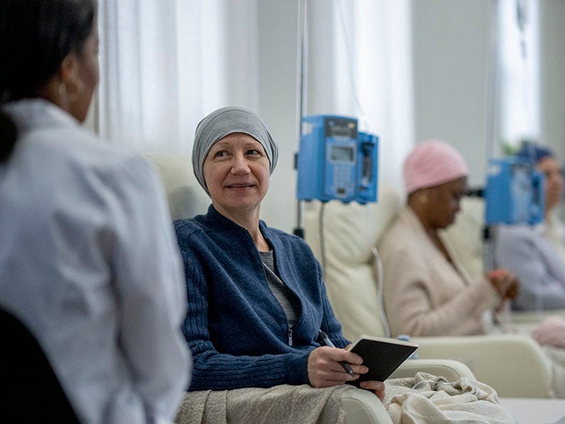 woman sitting in chair during chemotherapy treatment