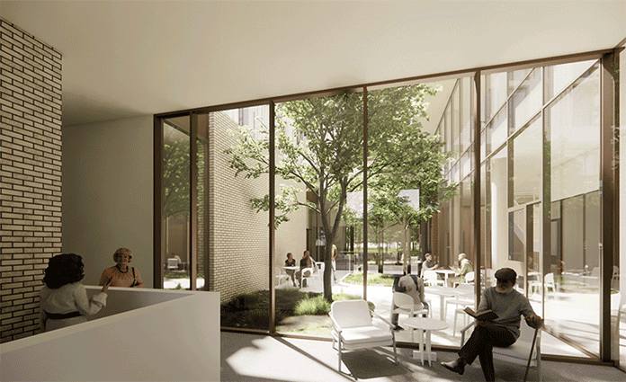 Sunlit lounge with large windows overlooking a green courtyard.