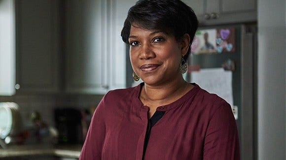 Cancer survivor, Joya, standing in kitchen