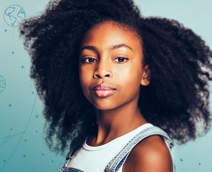 young African American girl in overalls