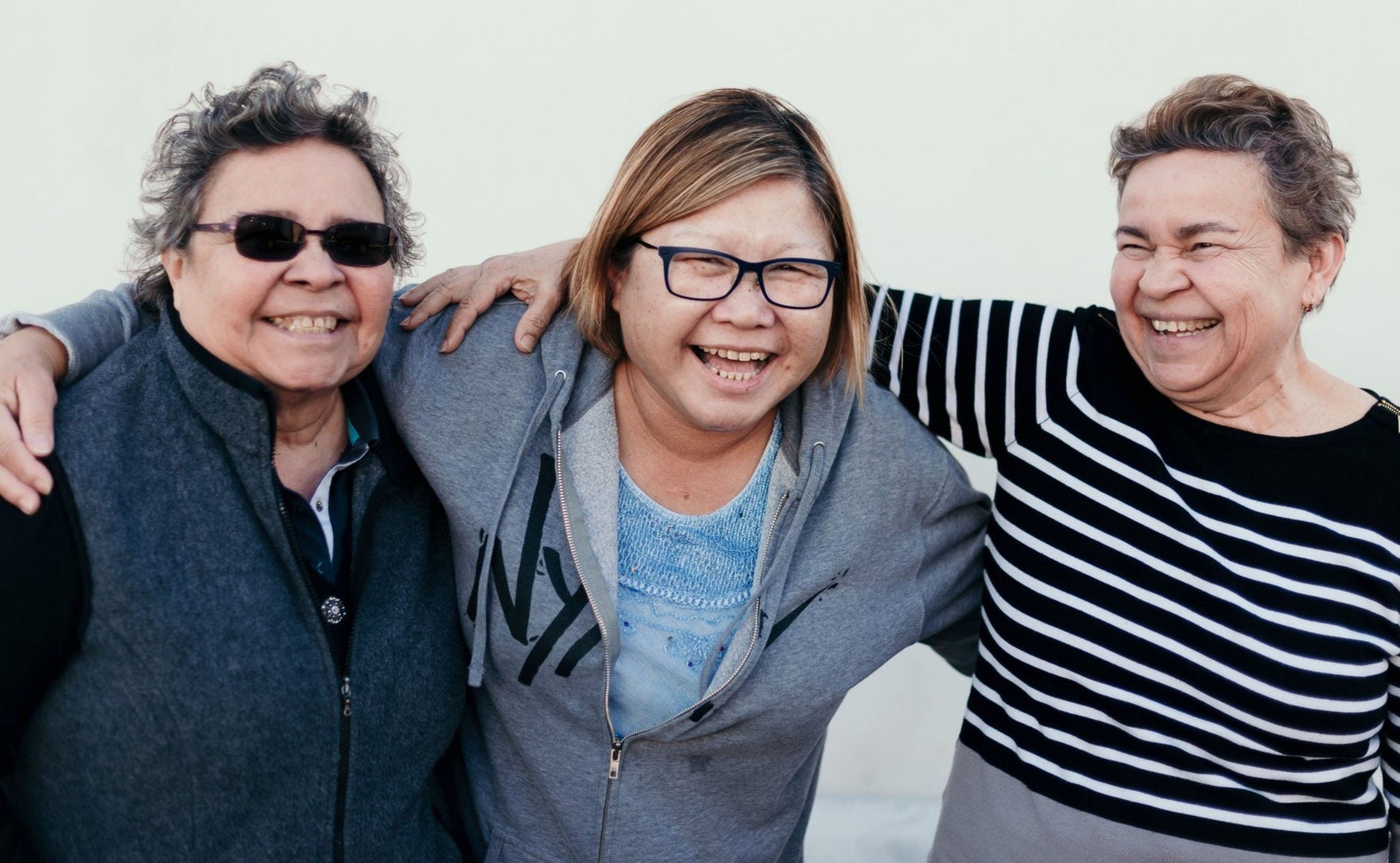 three older women hugging
