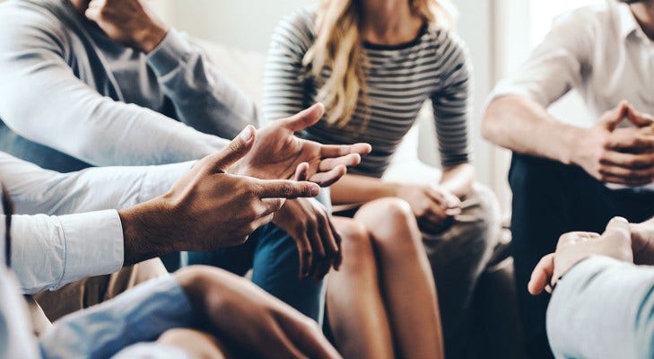 close up of hands of group of people in conversation